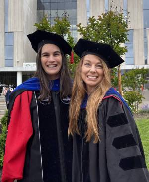 Two members of the REHAB Lab in regalia