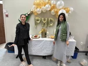 Two members of the department celebrating receiving their PhDs